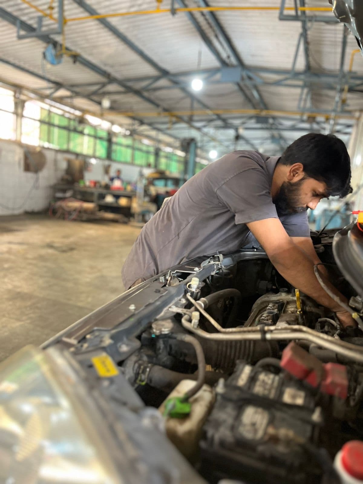 A technician servicing a car at Chamunda Motors